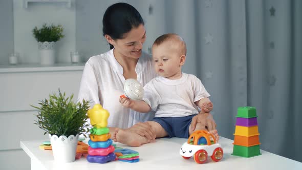 Mother and Baby with a Lot of Toys