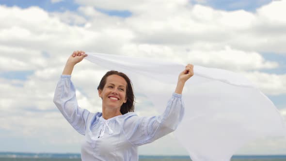 Happy Woman with Shawl Waving in Wind on Beach 26