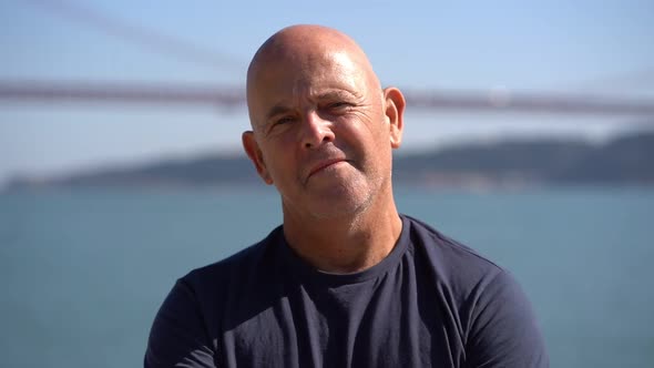 Portrait of Happy Elderly Man Standing at Riverside