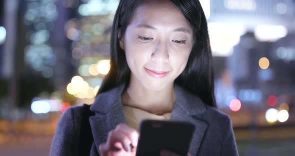 Woman use of cellphone at night