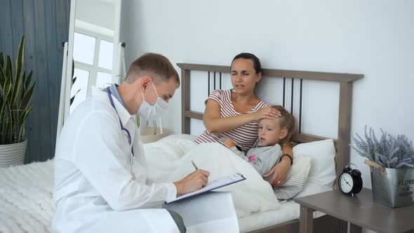 Doctor Consulting Mother with Child at Home