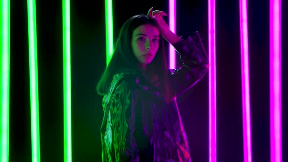 Portrait Young Pretty Woman Poses Against Dark Studio Background Bright Multicolored Neon Tubes