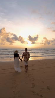 Couple Men and Woman Walking on the Beach During Sunset in Khao Lak Thailand