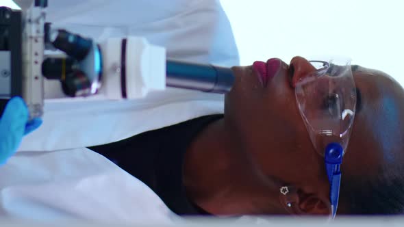 Vertical Video Close Up of Black Female Scientist Researching Using Microscope