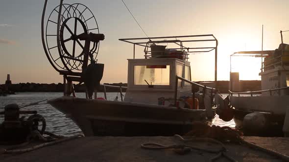 Moored Boat Bobs on the Waves at Sunset