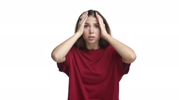 Shocked Girl in Red Tshirt Looking Ambushed Holding Hands on Head and Gasping Alarmed Standing Over