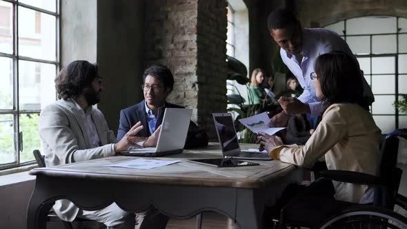 Multiracial business group of people working together at conference meeting inside office