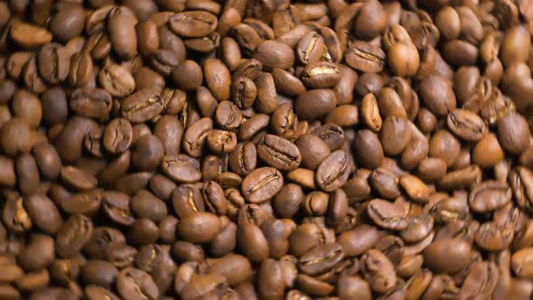 Freshly Roasted Coffee Beans Rotate in Slow Motion Top View