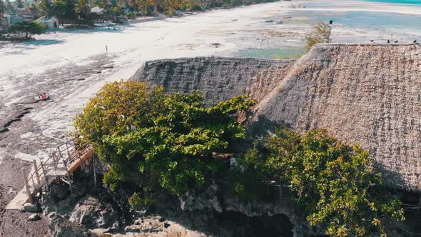 The Rock Restaurant in Ocean Built on Cliff at Low Tide on Zanzibar Aerial View
