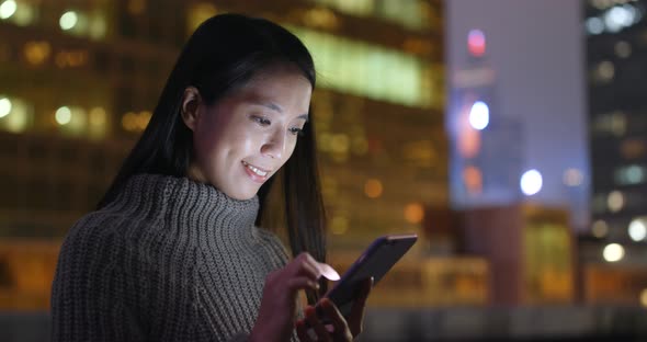 Woman use of mobile phone at night