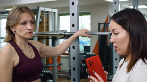 Two Women are Chatting in the Gym