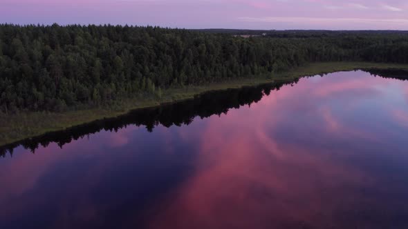 Aerial photography of the lake swamp from a drone at sunset with beautiful sun flares. reflection of