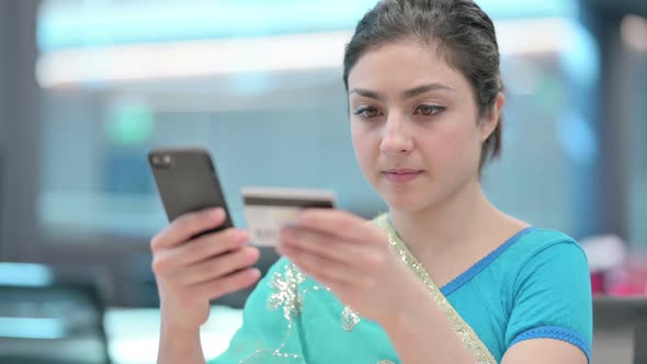 Close up of Indian Woman making Online Payment on Smartphone