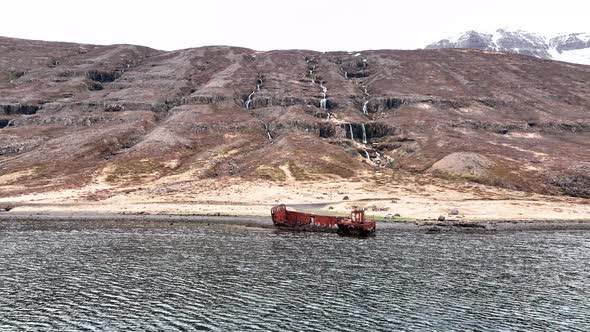 Abandoned Shipwreck In Mjoifjordur, East Iceland - aerial forward