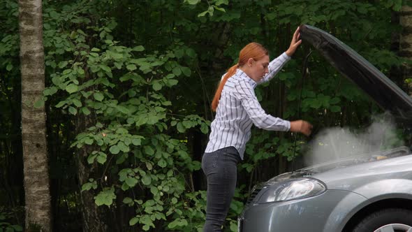 Woman Opening Car Hood and Looking at Engine. 