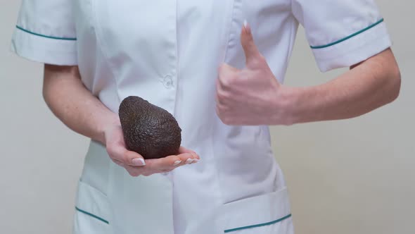 Nutritionist Doctor Healthy Lifestyle Concept - Holding Organic Avocado