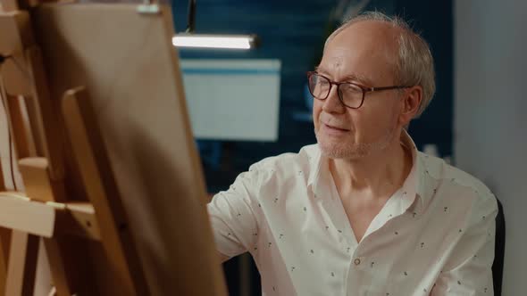 Retired Man Using Artistic Technique and Pencils to Draw Masterpiece