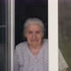 The Old Woman Looks Out of the Window and Smiles. - VideoHive Item for Sale