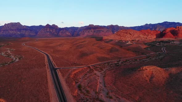 Morning aerial panorama of southwest highways approaching Red Rock Canyon near a small rural  mounta