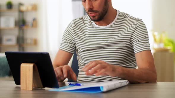 Man with Tablet Pc Having Video Call at Home