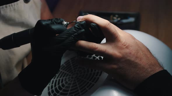 Hardware Manicure - Master Doing Manicure with a Small Grinder on Male Hands