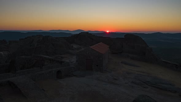 Spectaculat rising sun on horizon seen from ruins of Monsanto Castle, Portugal. Time-lapse