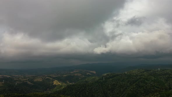 Aerial time lapse of developing clouds, over hills