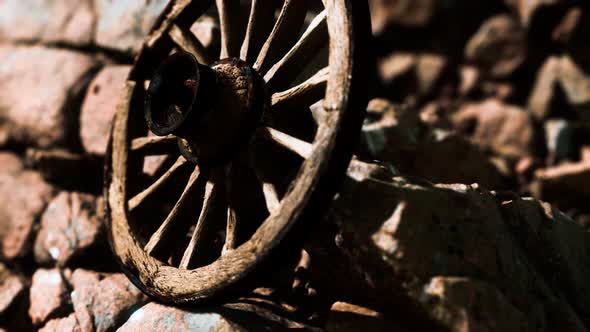 Old Wooden Wheel on Rocks