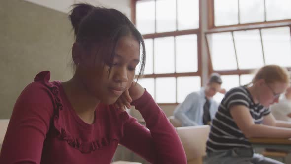 African american girl writing in class