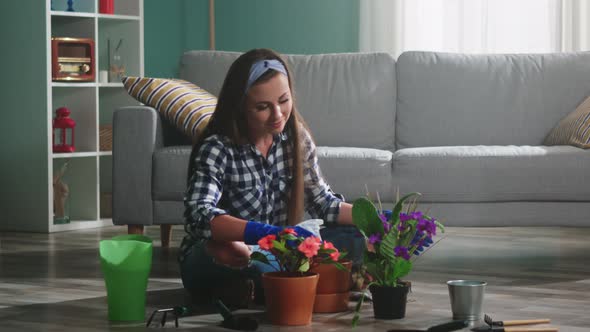 Woman Florist Is Taking Care of Plants