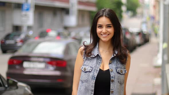 Portrait of beautiful smiling caucasian girl on the street