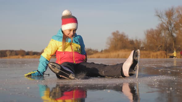 A Little Girl Enjoying Ice Skating at Frozen Lake in Winter Season. Winter Sports