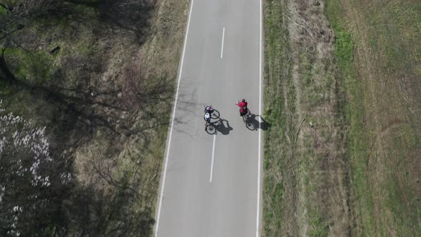 Aerial View of Happy Man and Woman on Bikes Riding on the Road