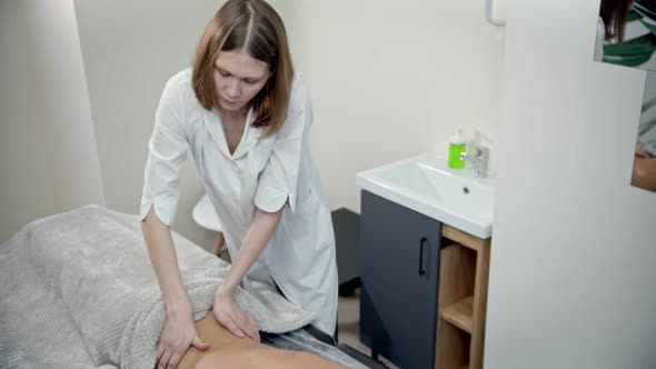 Massage - Woman Massage Therapist Is Conducting a Back Massage