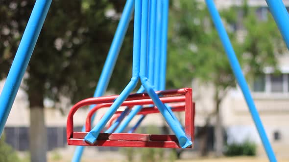 Empty Metal Swings In Playground