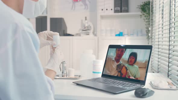 Asian veterinarian girl talk to pet owner on online virtual video call.