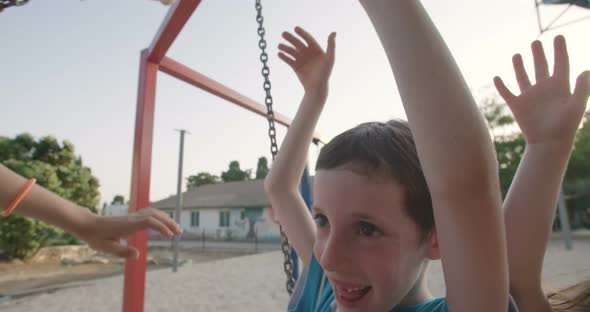 Children swinging together at a public playground