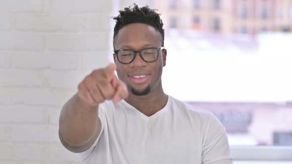 Portrait of Cheerful Casual African Man Pointing at the Camera 