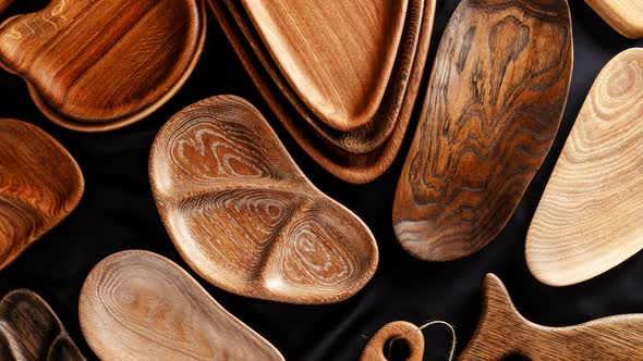 Rich Variety of Wooden Empty Cutting Boards and Plates on Dark Background