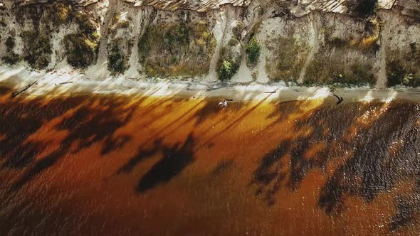 Beautiful Couple Walking on the Beach Aerial View Sun Rays