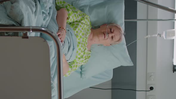 Vertical Video Portrait of Old Woman Sitting in Hospital Ward Bed to Cure Disease