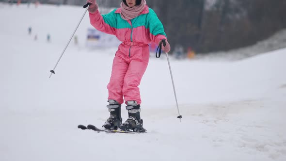 Concentrated Female Skier Skiing to Camera in Slow Motion and Leaving