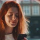 Attractive young woman smiling and using a smartphone - VideoHive Item for Sale
