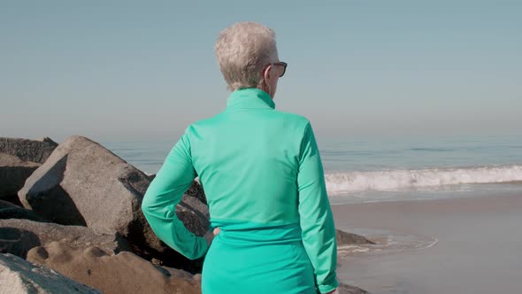 Senior Woman Exercising At The  Beach
