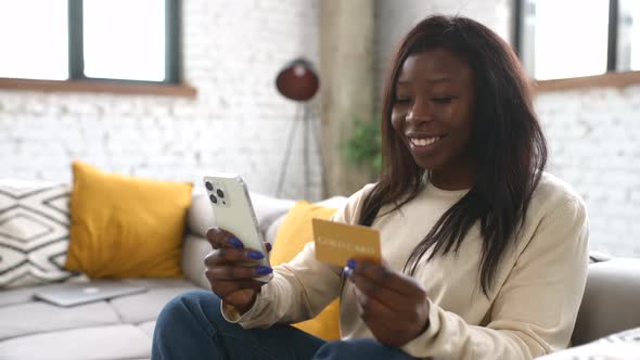 Cheerful Young Multiracial Woman Using Smartphone Shopping App for Buying Online