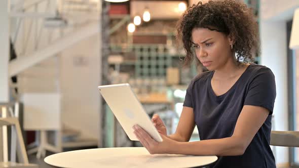 Failure Young African Woman with Loss on Tablet in Cafe