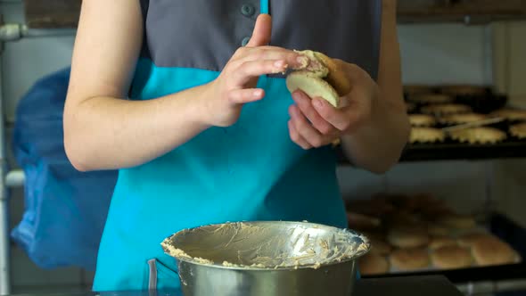 Woman Applying Cream on Crunchy Cookie