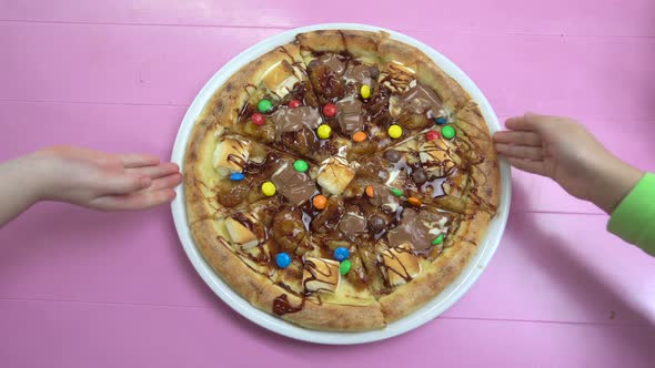 Close-up Motion of Pizza with Melted Chocolate and Multicolored Candies