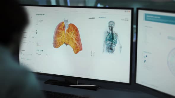 A Medical Doctor is looking at Monitors and Inspecting Detecting the Coronavirus alt