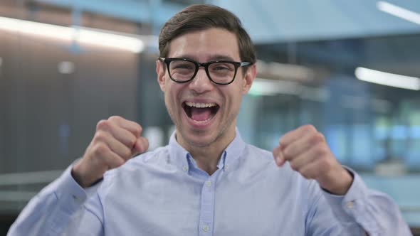 Portrait of Successful Young Man Celebrating